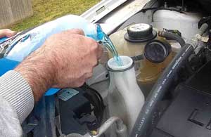 Putting Windshield Washer Fluid in Car